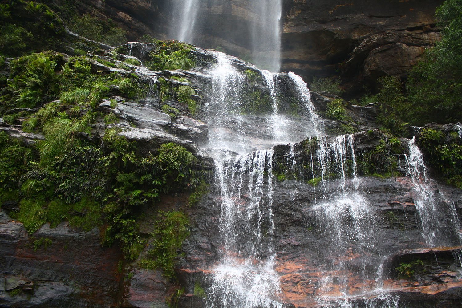 waterfall cascading over mossy rocks