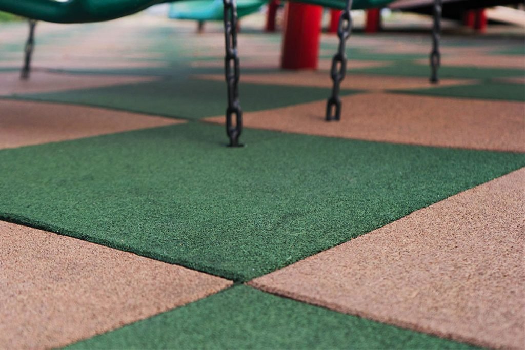 Word2 rubber playground tiles Close up of checkered playground tiles