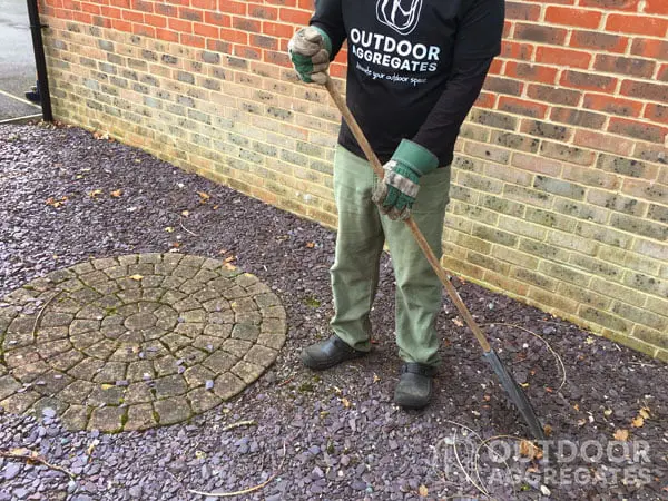 1 Raking a slate chip parking area