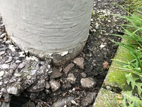  Hardcore visible under tarmac around a lamp post