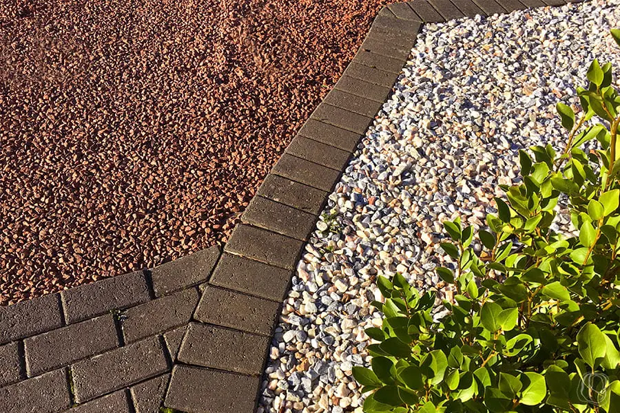 Red brick edging between gravels on a driveway