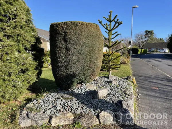  Green granite boulder edging around slate chippings