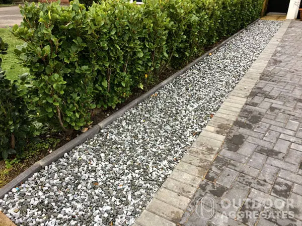  Black and white stones along a paved driveway